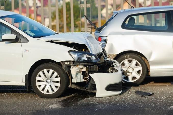 Two cars involved in a rear-end collision on a busy Virginia Beach commuter road with visible bumper damage